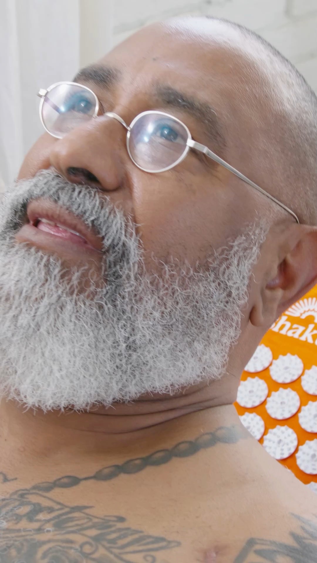 Man lying back with his head on a Shakti pillow