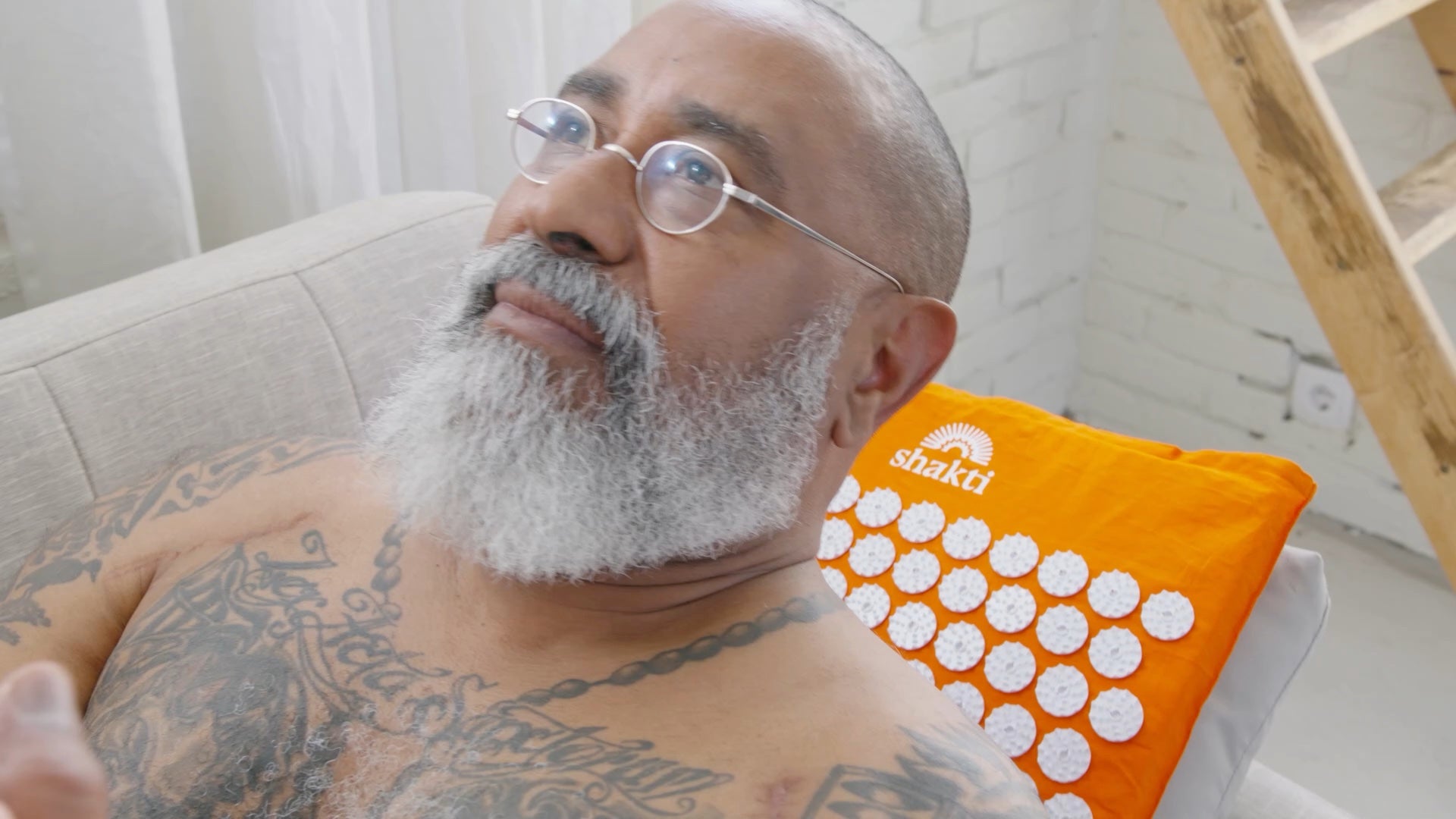 Man lying back with his head on a Shakti pillow